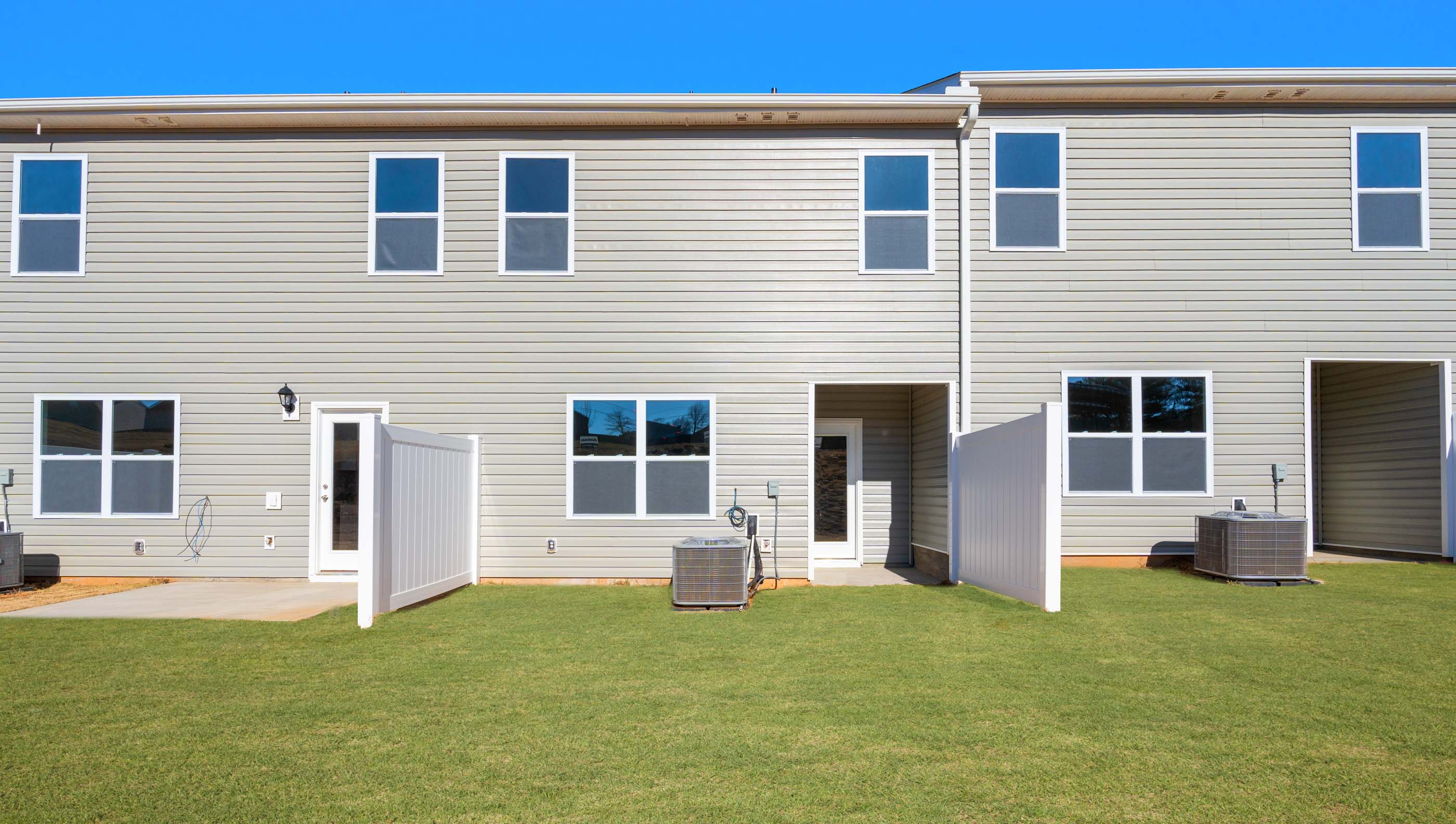 Back exterior of home with large backyard.