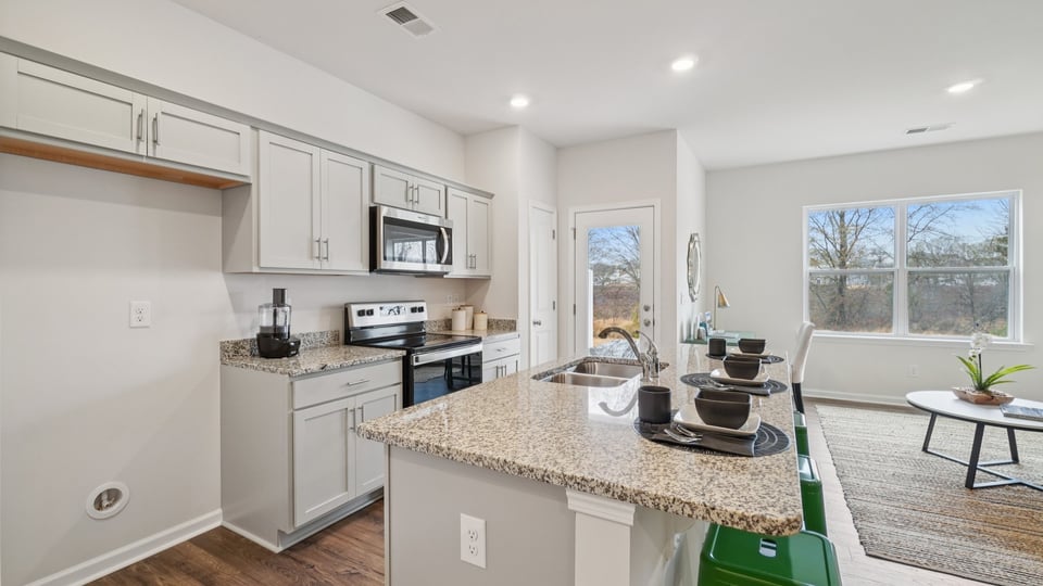 Kitchen and island with stainless steel appliances.