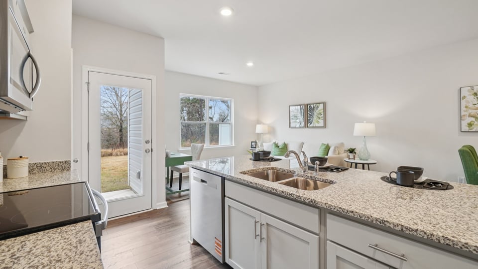 Kitchen and island with stainless steel appliances.