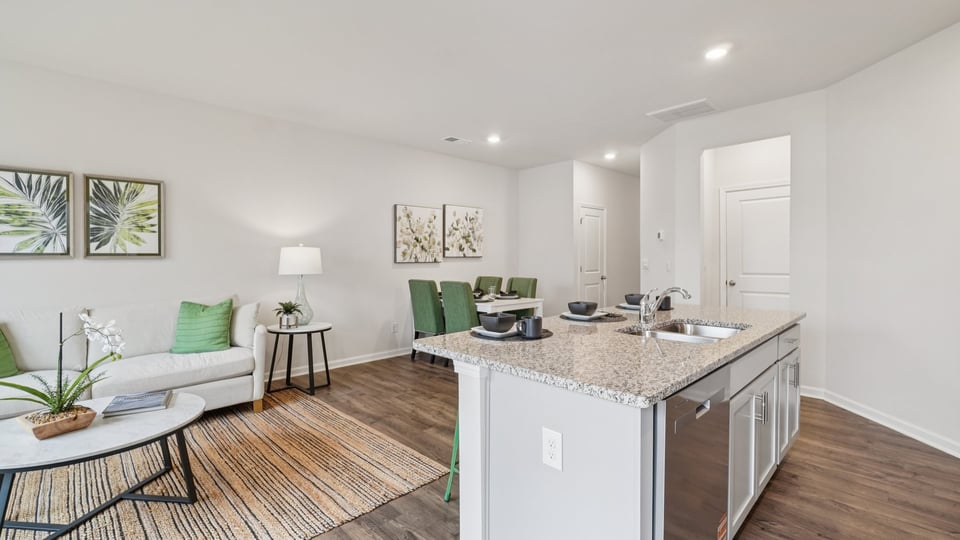 Kitchen and island with stainless steel appliances.