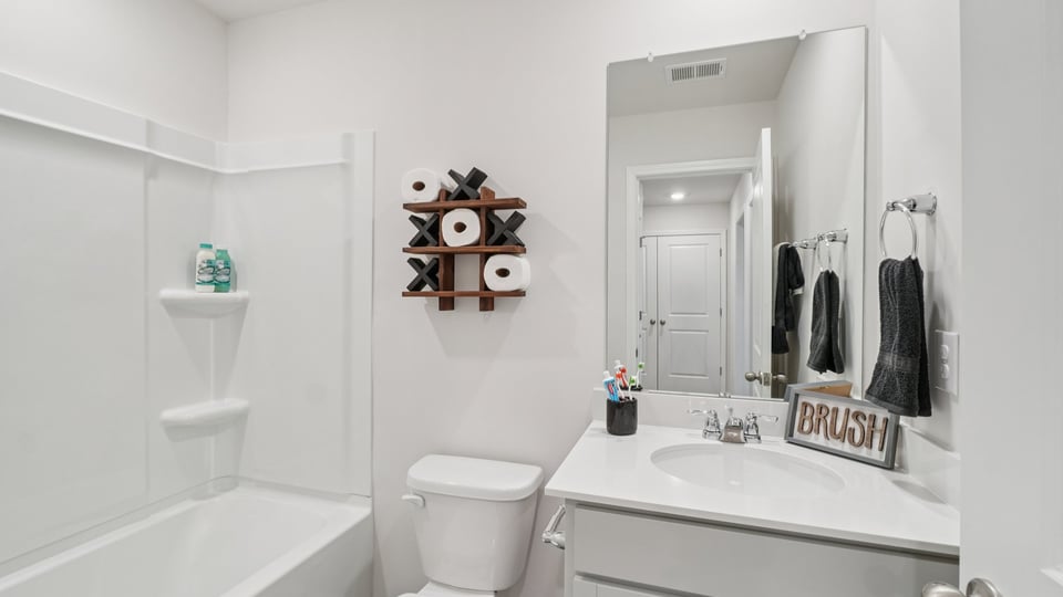 Bathroom with single vanity sink and tub.