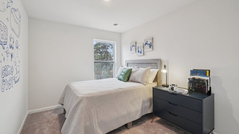 Bedroom with carpet and window.