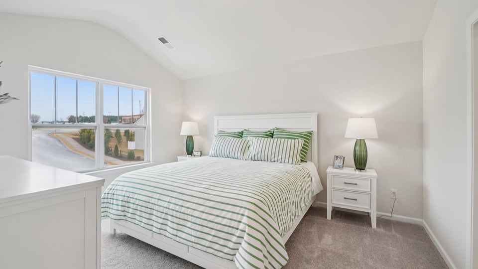 Bedroom with carpet and window.