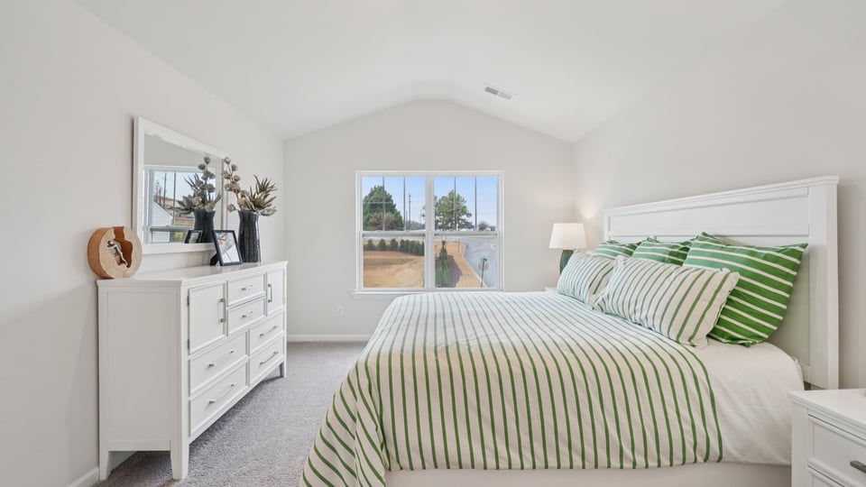 Bedroom with carpet and window.