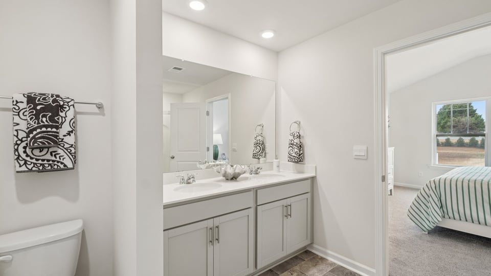 Bathroom with shower and double vanity sink.