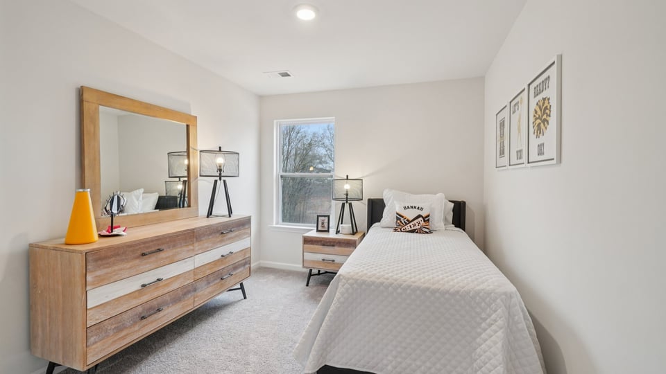 Bedroom with carpet and window.