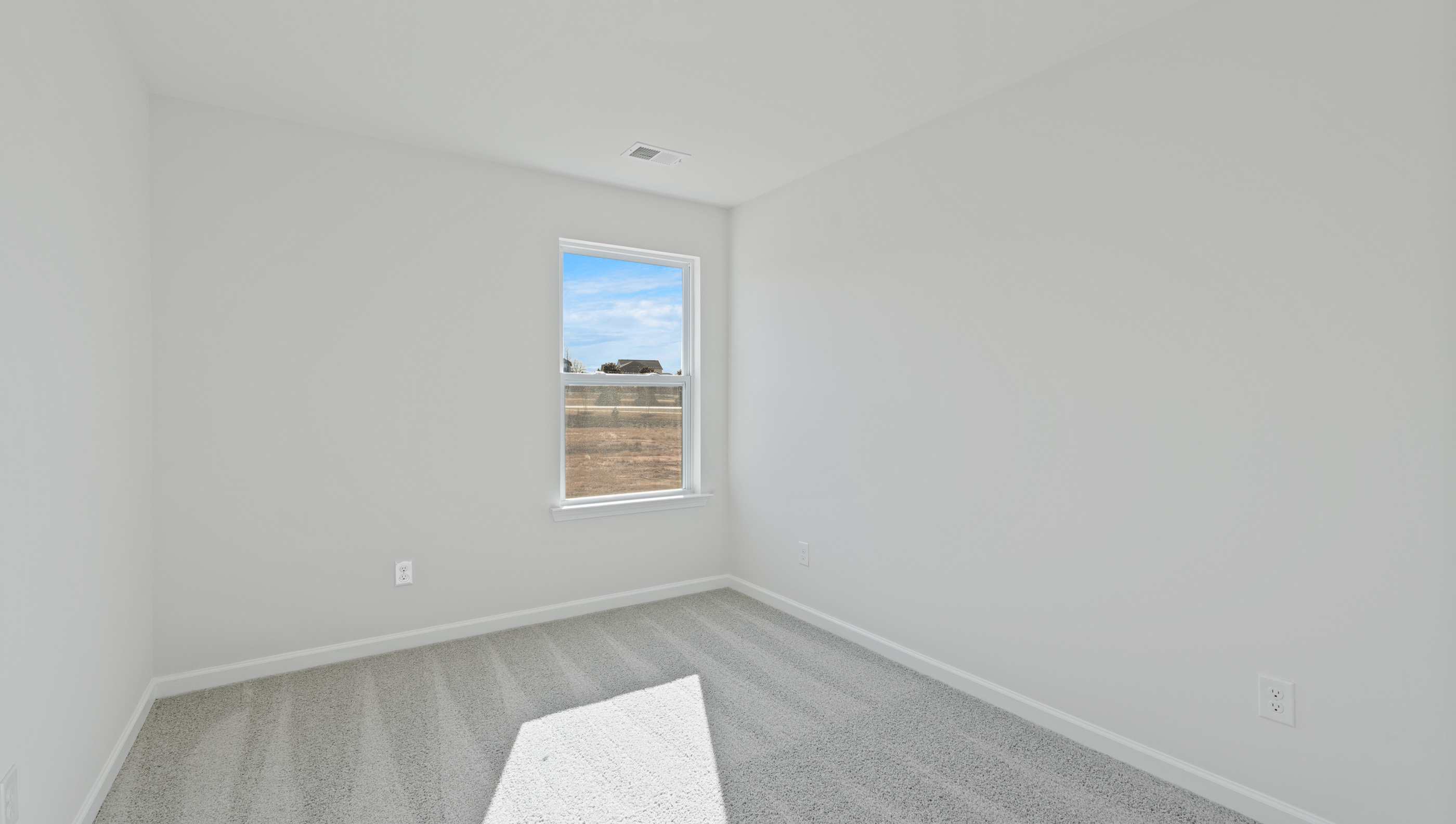 Bedroom with window and carpet.