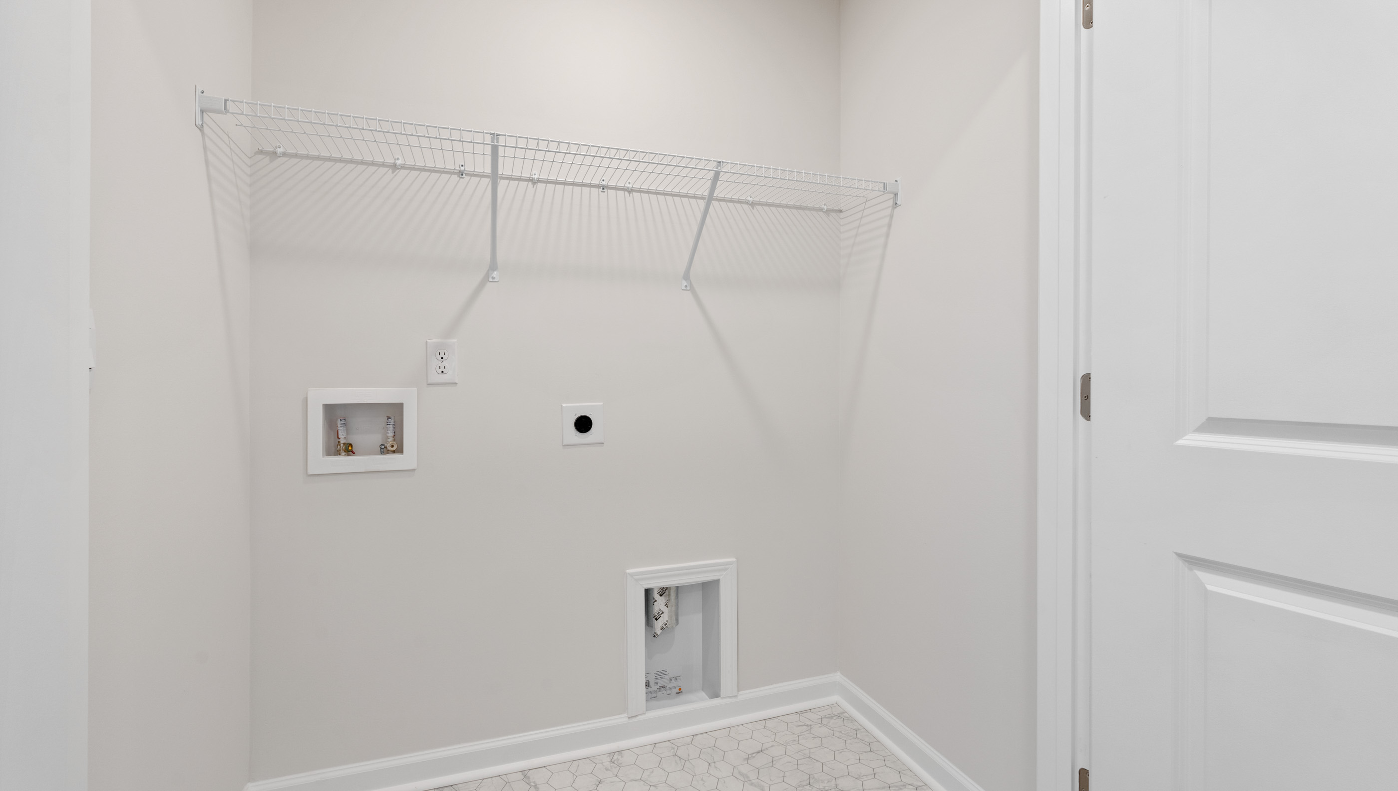 Laundry room with shelving.