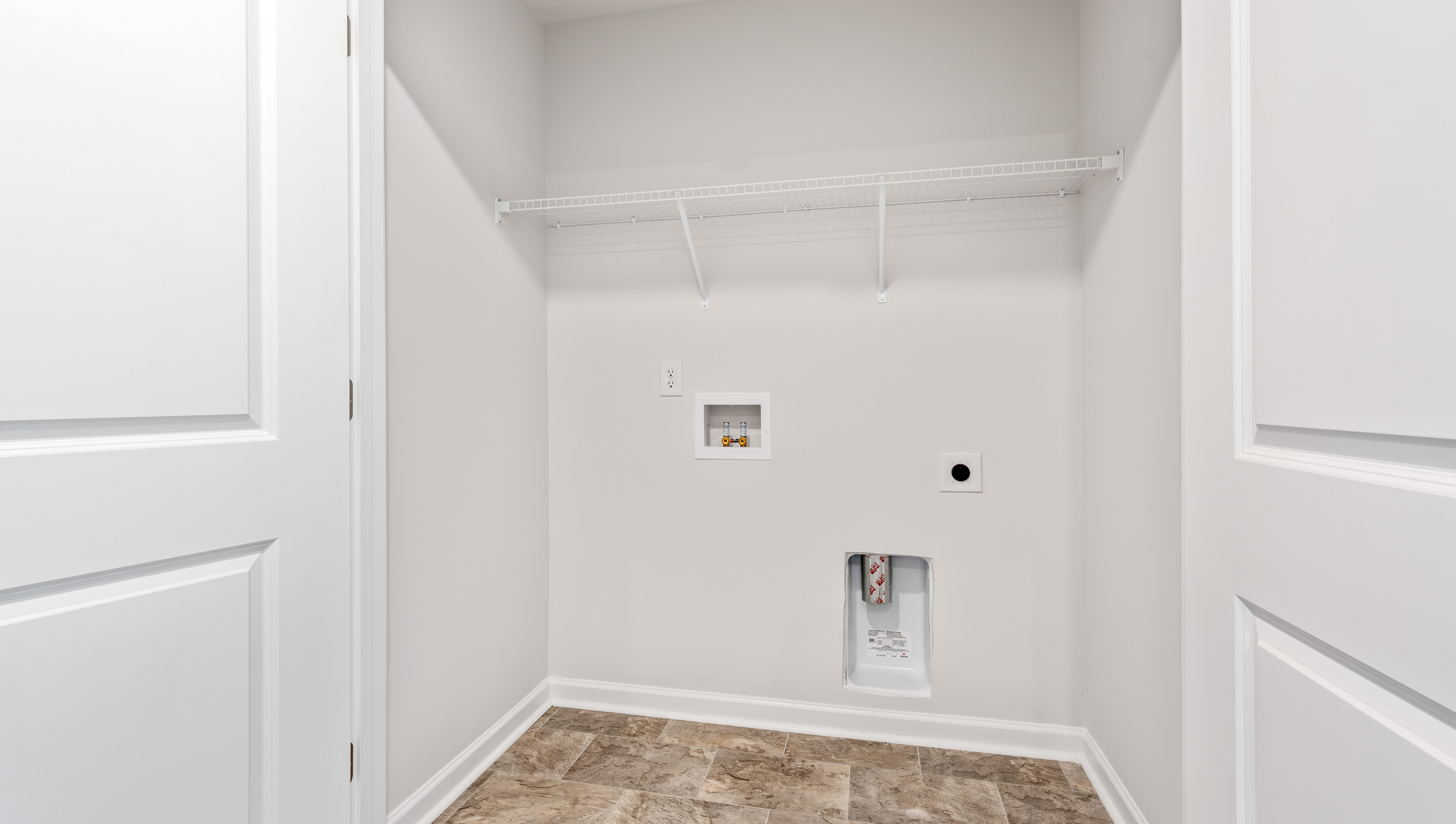 Laundry room with shelving.