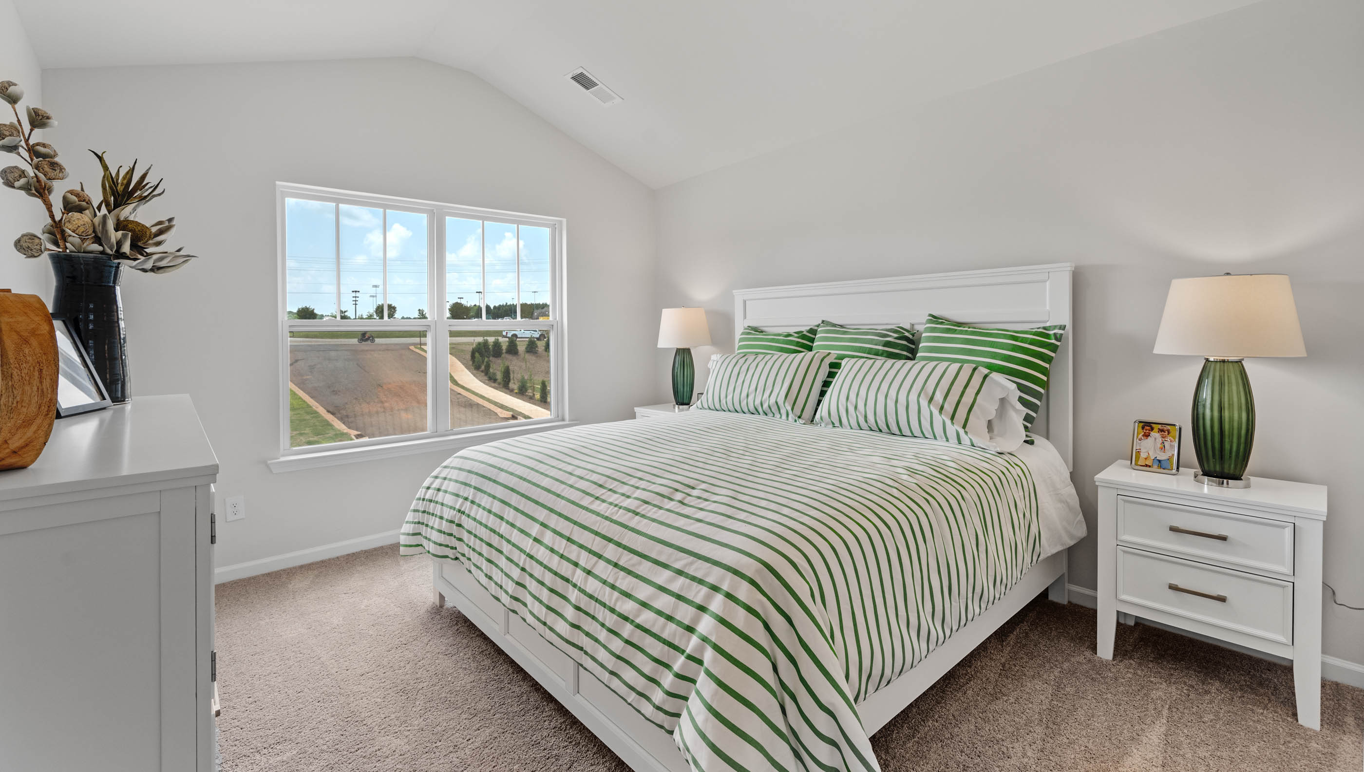 Bedroom with carpet and window.