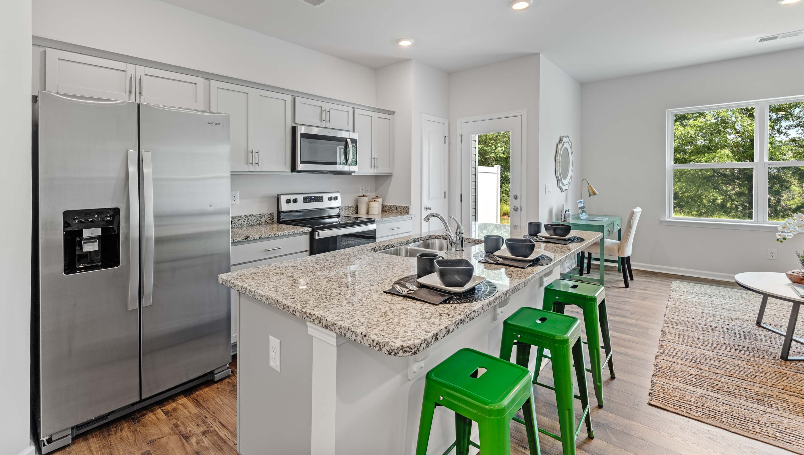 Kitchen and island with granite counter tops.