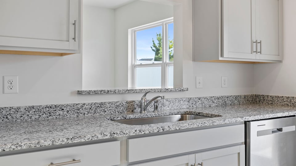 Look through opening into between the kitchen and dining area.