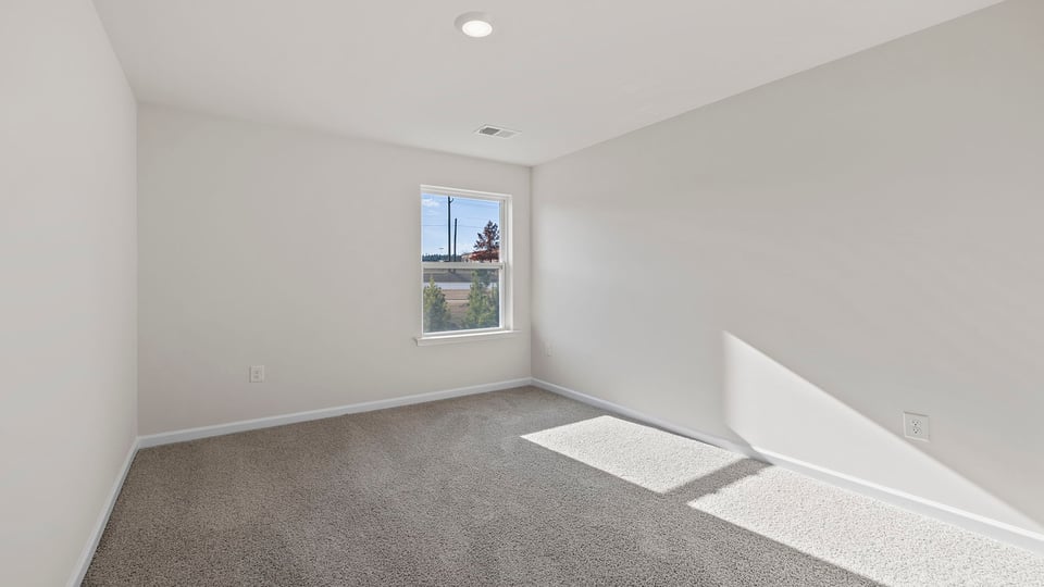 Bedroom with window and carpet.