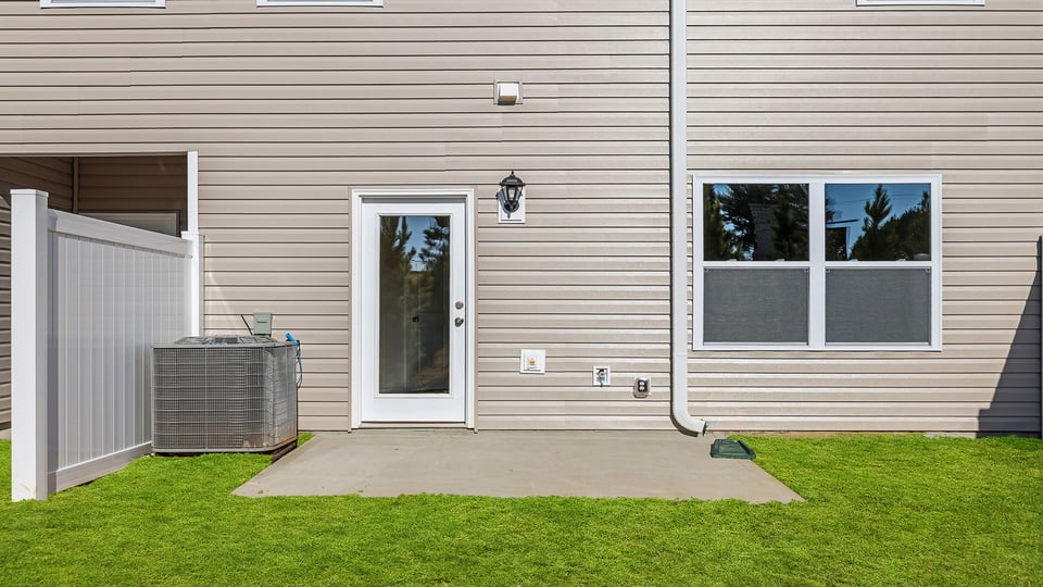 Back exterior view of home and patio.