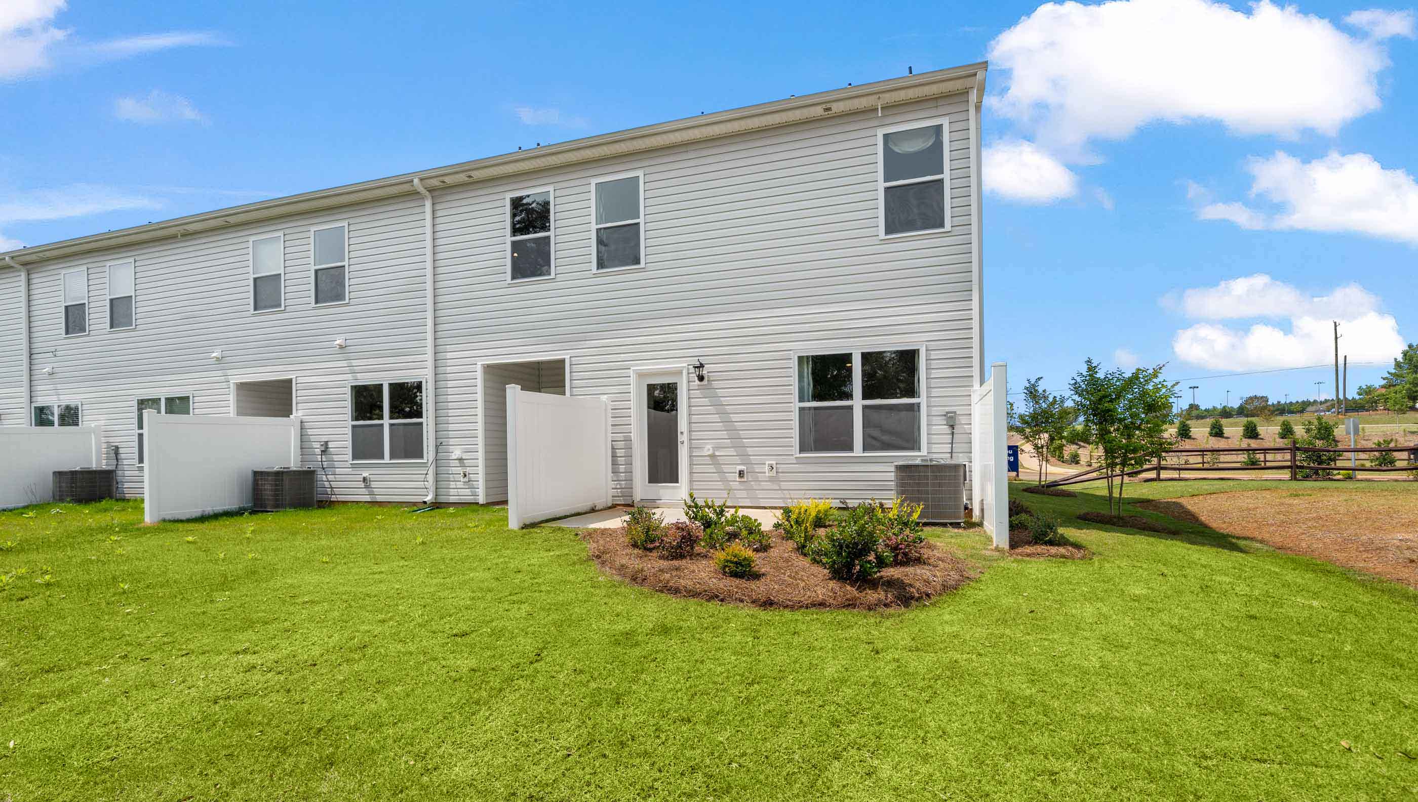Back exterior of home with large backyard.