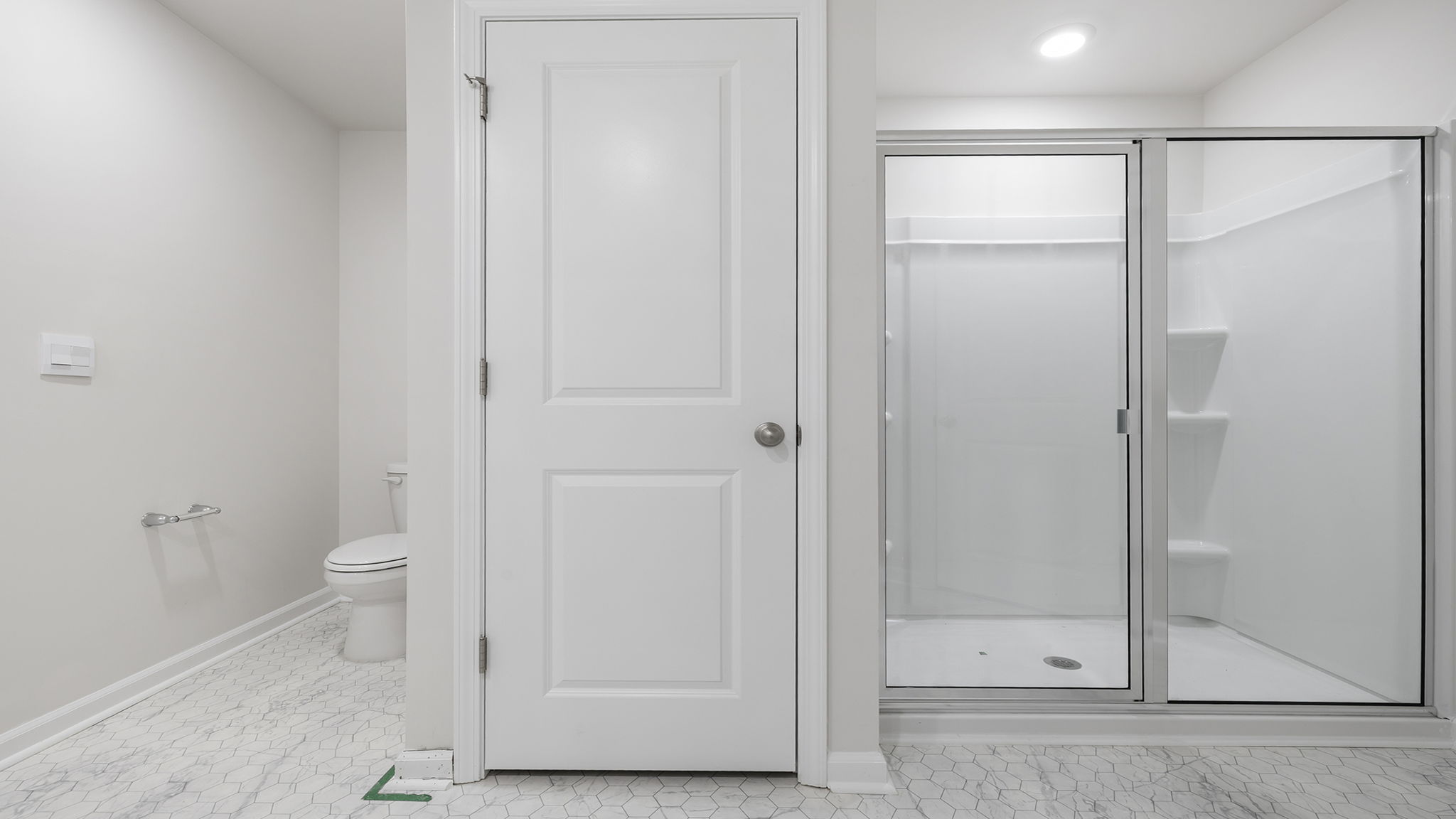 Primary bathroom with dual sink vanity and mirrors.