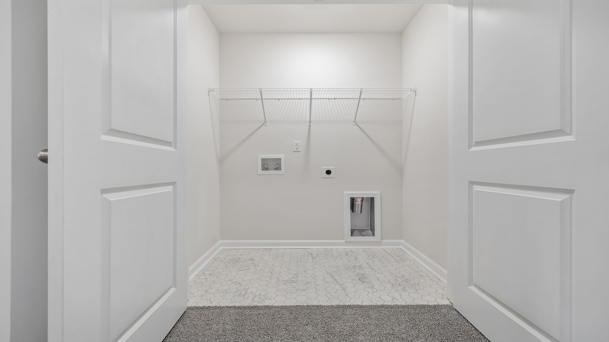 Laundry room with shelving.