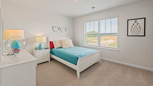Bedroom with carpets and windows.