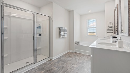 Primary bathroom with shower and bathtub.