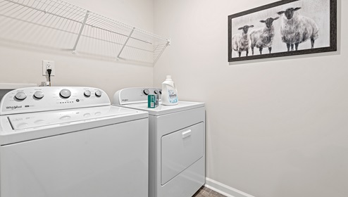 Laundry room with hanging shelves.