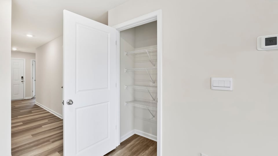 Primary closet with shelf.