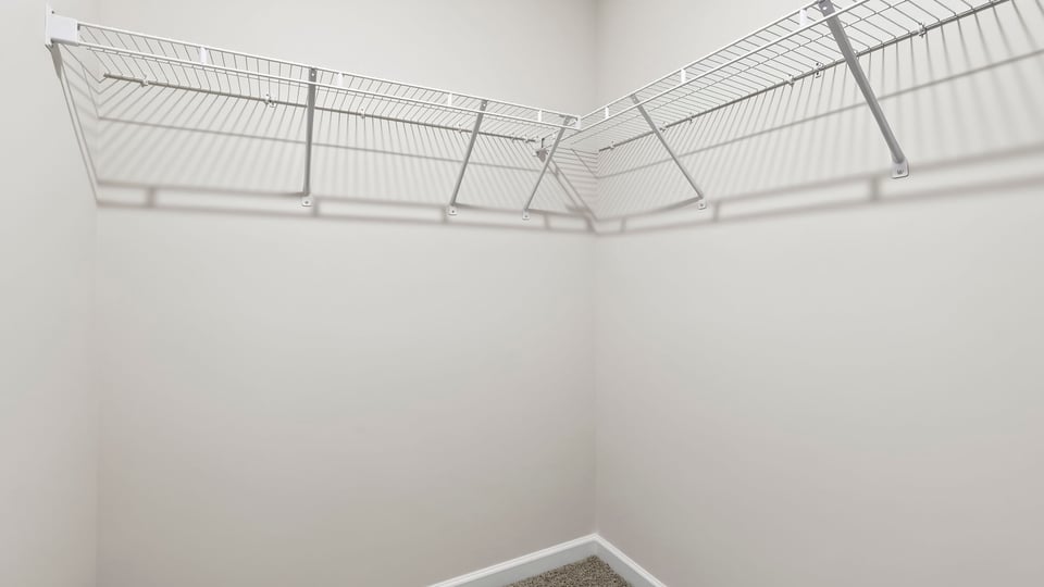 Primary closet with shelf.