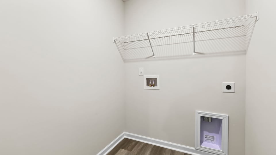 Laundry room with shelf.