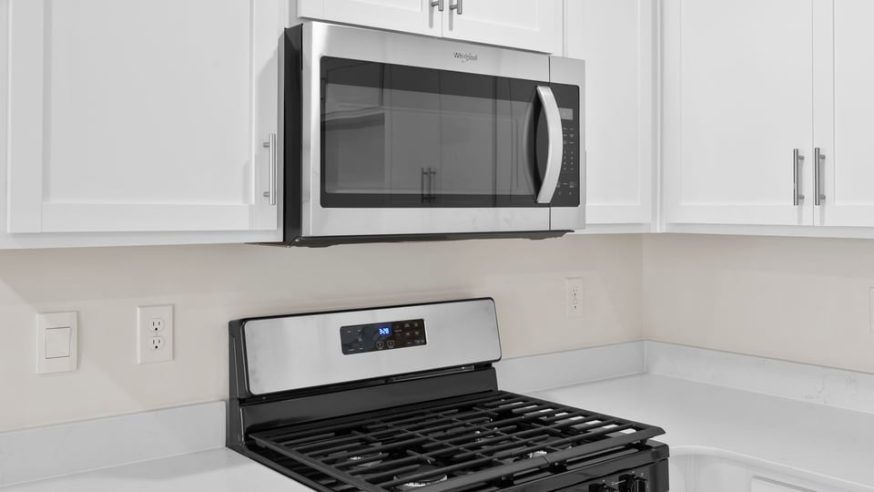 Kitchen with cabinets and windows.