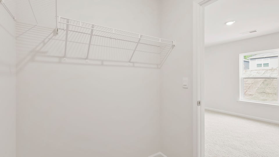 Primary closet with shelf.