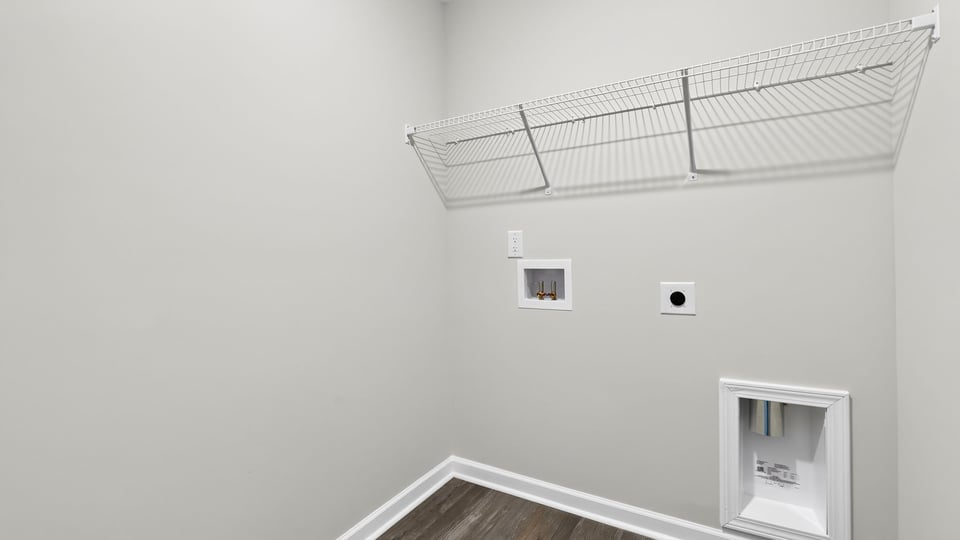 Laundry room with hanging storage racks.