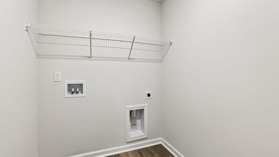 Laundry room with hanging storage racks.