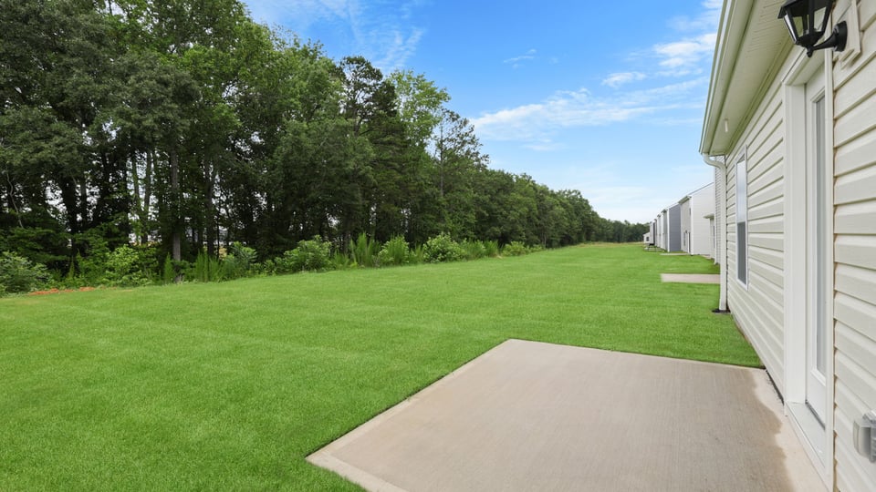 Back exterior of home with patio.