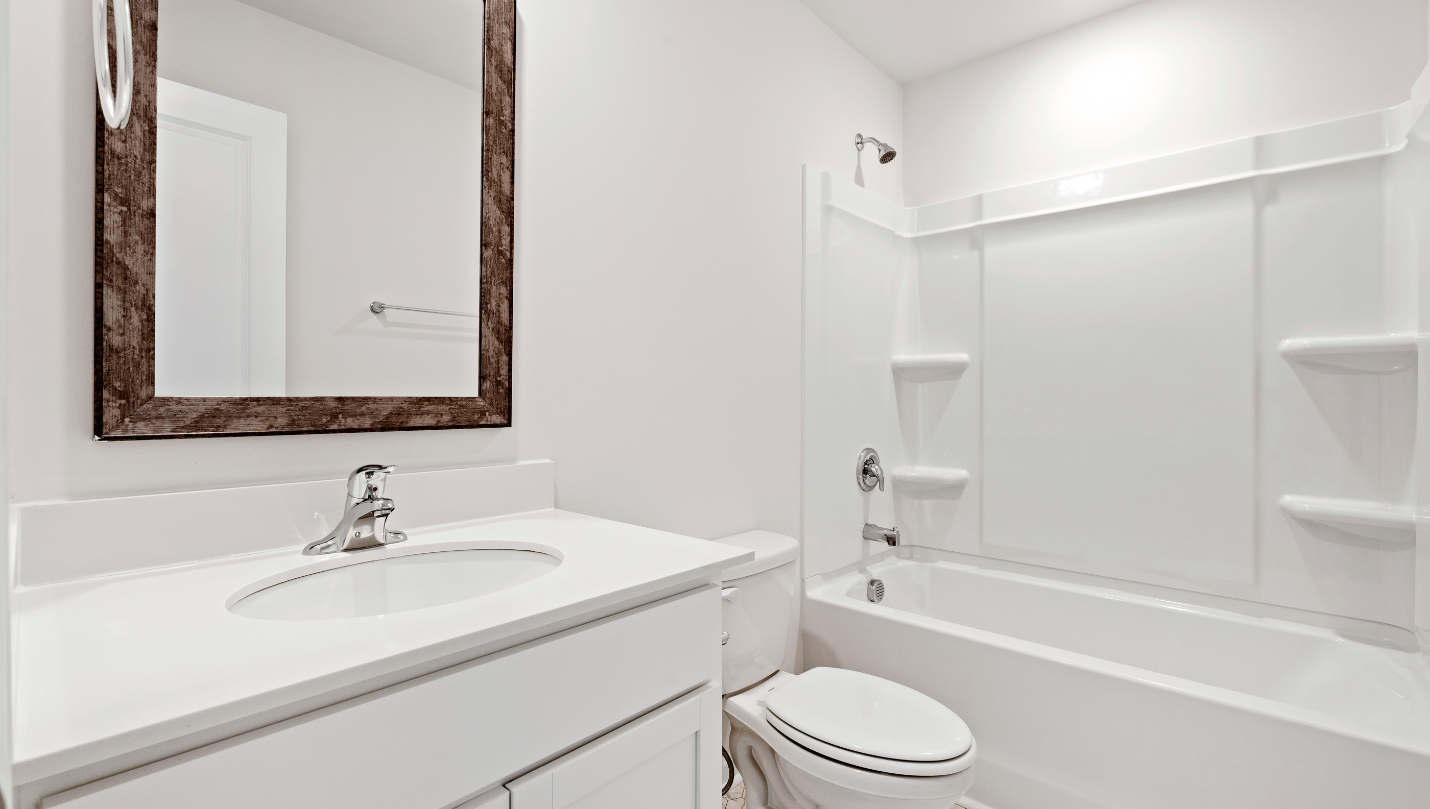 Hall bathroom with vanity and combination shower / tub.