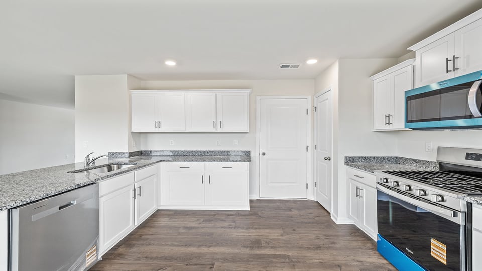 Large kitchen with lots of cabinets.