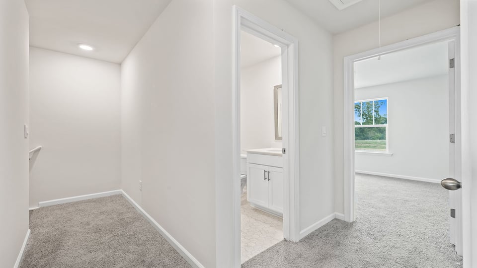 Upper level hallway and view of bath and bedrooms.