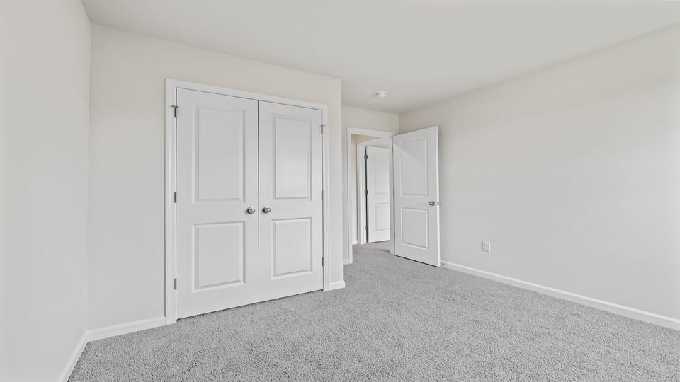Bedroom with window and carpet.