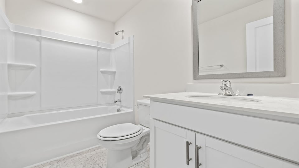 Hall bathroom with vanity and combination shower / tub.
