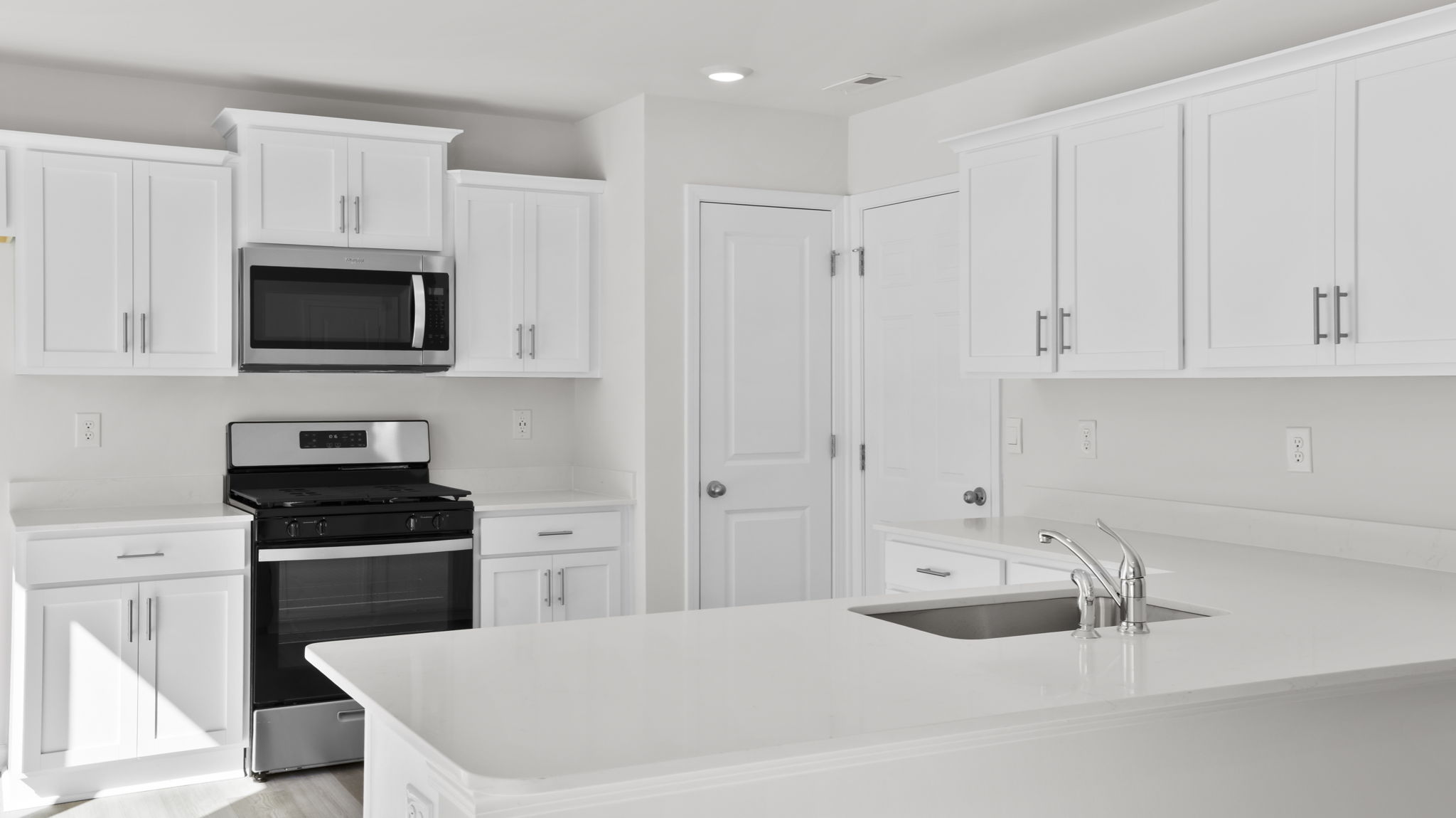 Kitchen with white cabinetry.