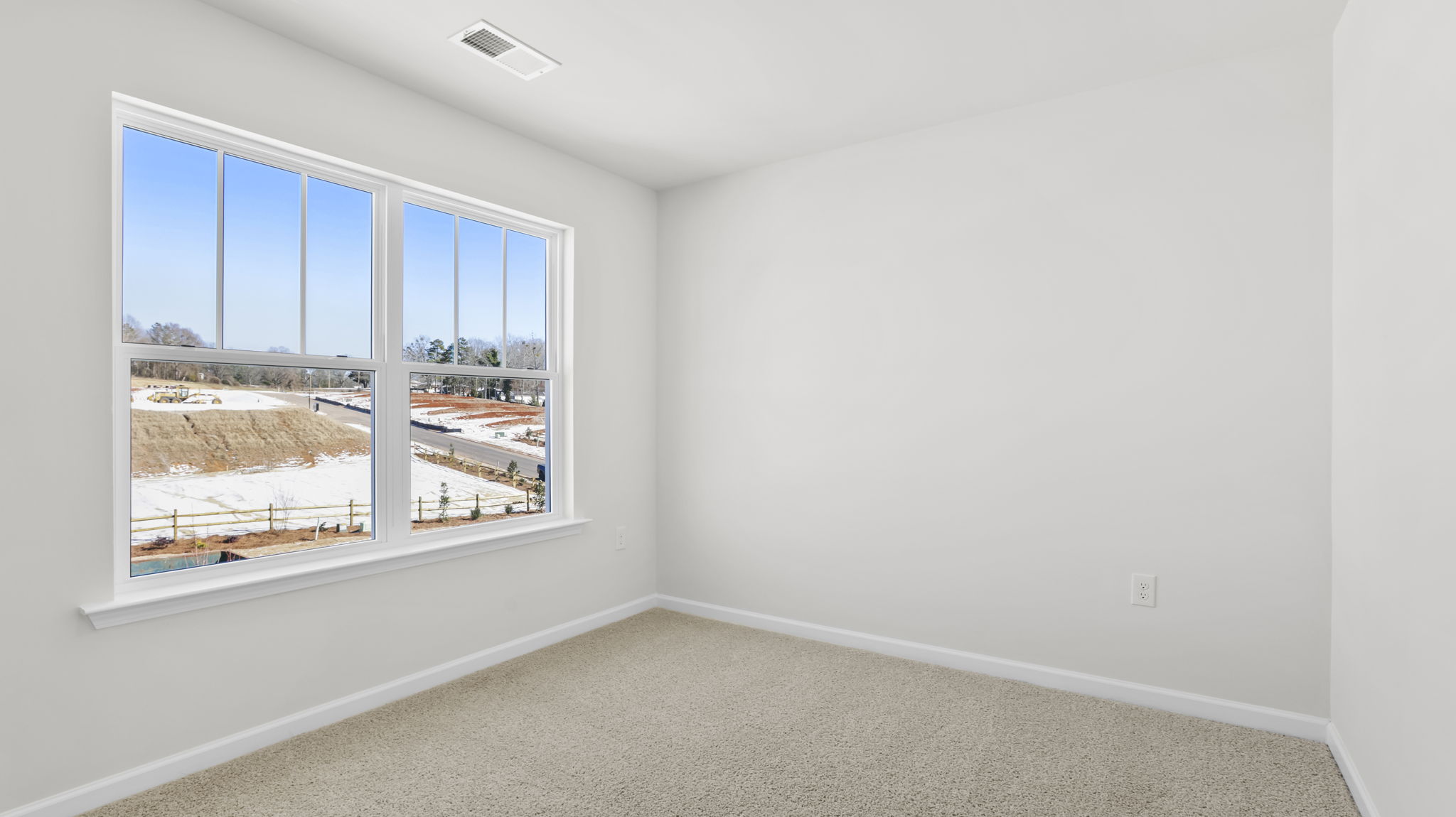 Bedroom with window and carpet.