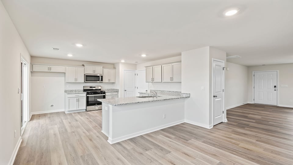 View of the kitchen and the entrance into the family room.