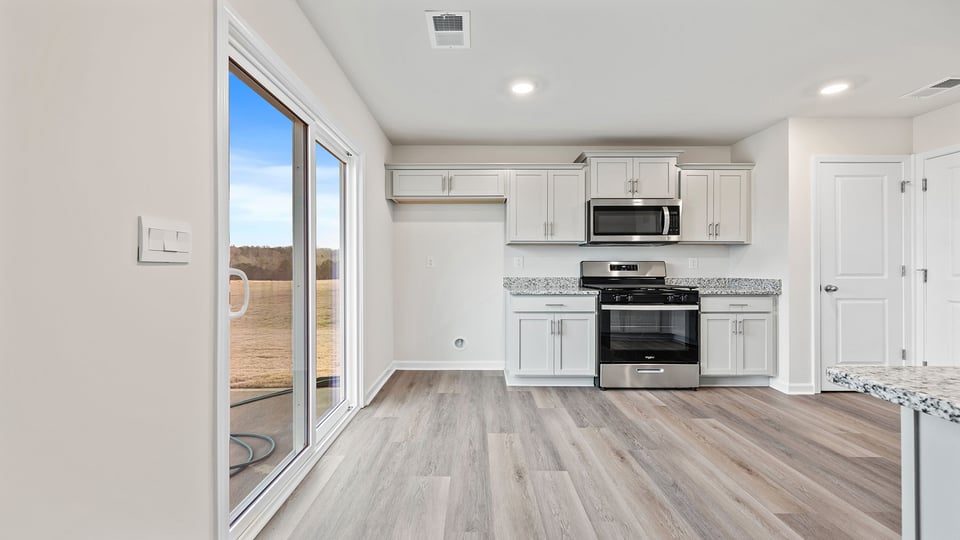 View from the dining area of the kitchen and door to the backyard.