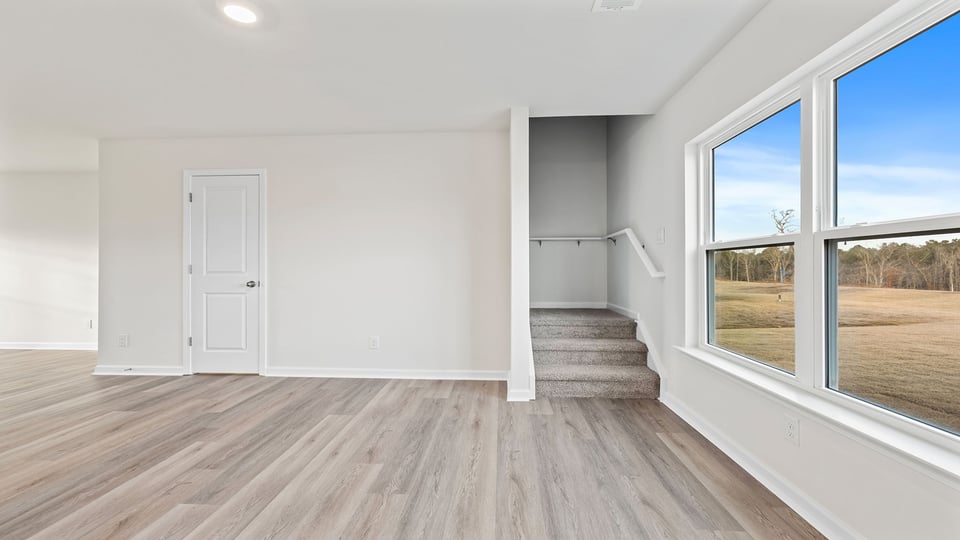 View of the dining area and the stairwell to the upper level.