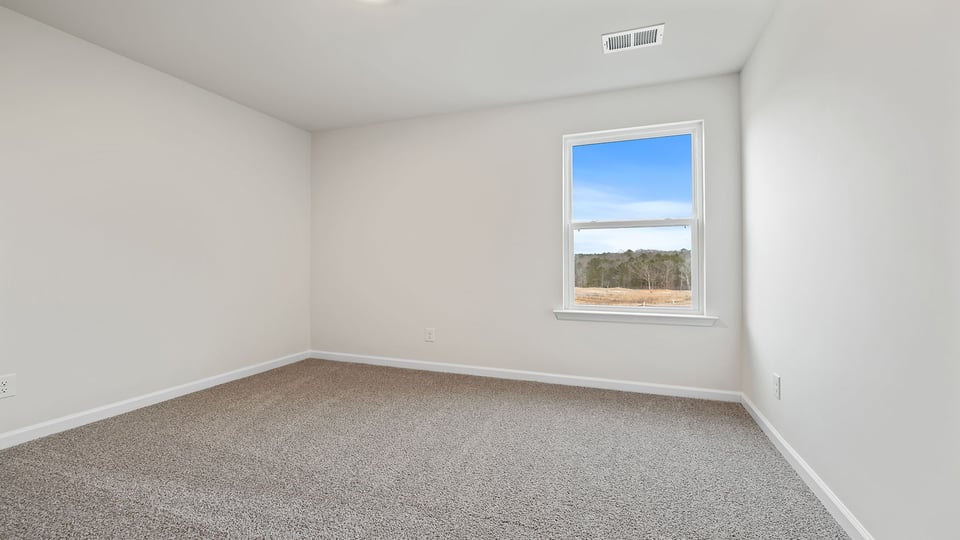 Bedroom with window and carpet.
