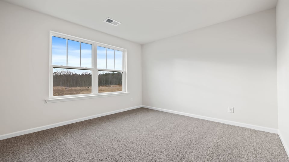 Bedroom with window and carpet.