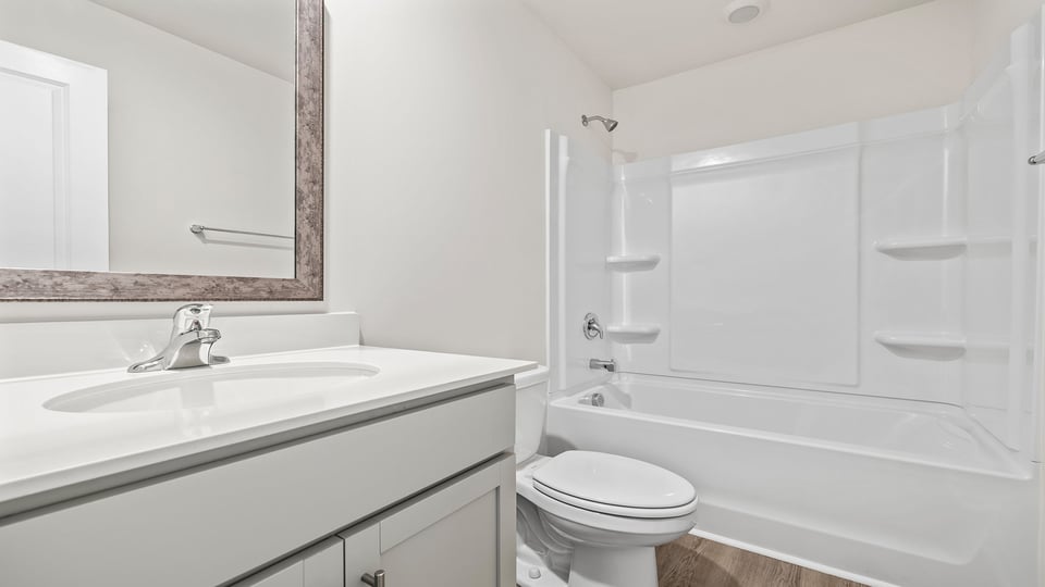 Hall bathroom with dual sink vanity with shower / tub.