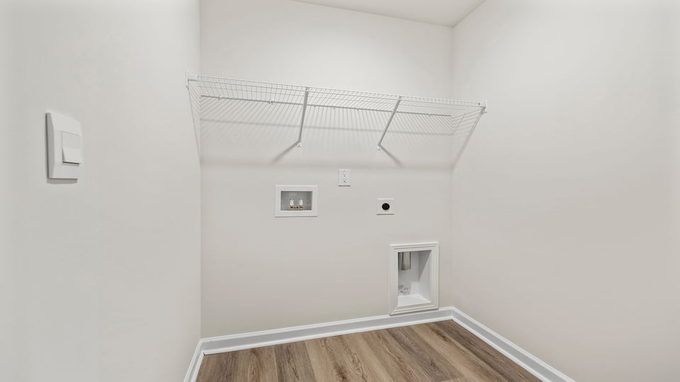 Walk-in laundry room with shelving.