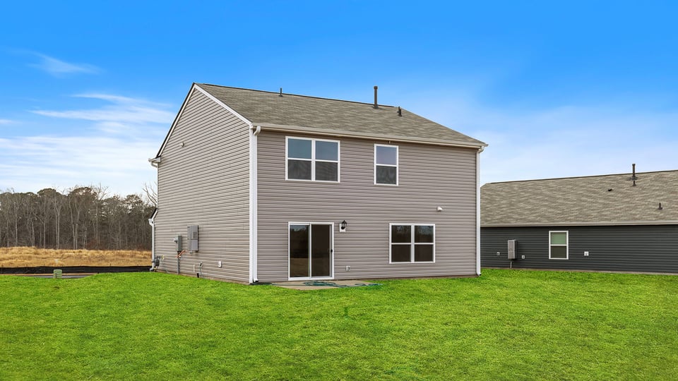 Back exterior view of home and patio.