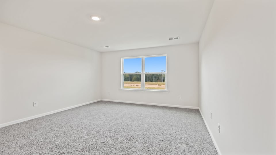Primary bedroom with large window.