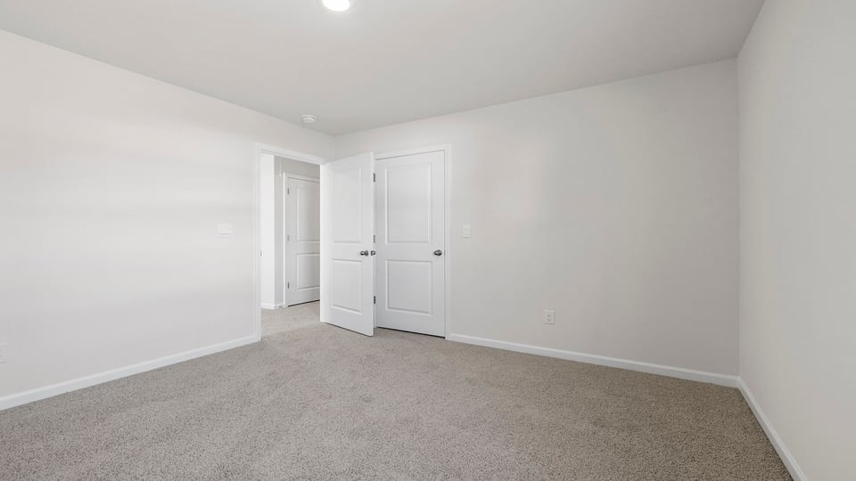 Bedroom with window and carpet.
