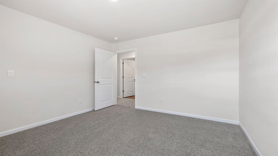 Bedroom with window and carpet.
